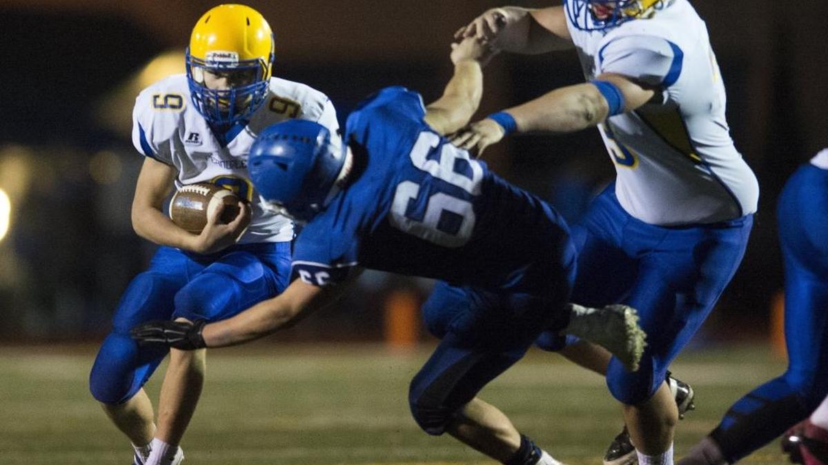 Ferndale’s Justice Powell looks to run through a hole from a big block by teammate Nick Bartel on Sedro-Woolley’s Joey Pittis on Oct. 29.