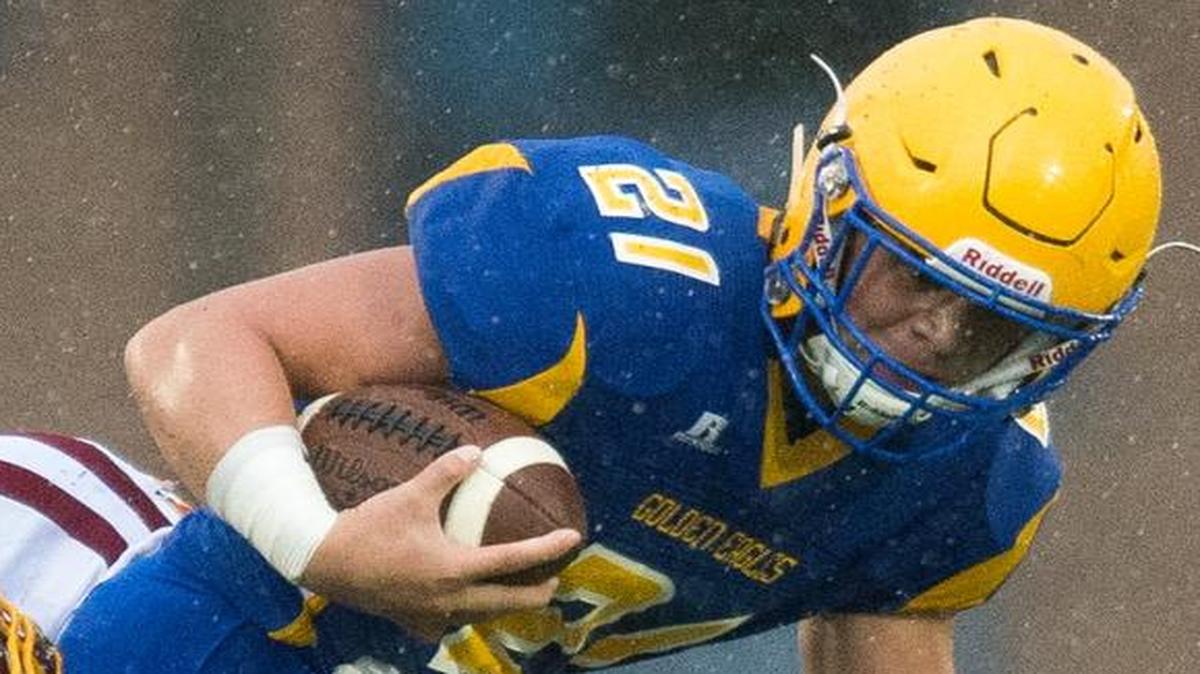 Ferndale's Cole Semu drags two Capital defenders Nov. 5 at Civic Stadium in Bellingham.