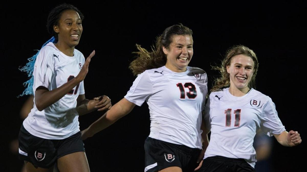 Bellingham’s Peyton Schwinger (13), Jillian Langei (11) and Jaden Stevenson celebrate during the Red Raiders' 3-2 win over Squalicum Sept. 19.