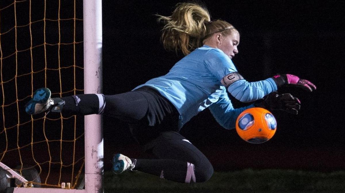 Meridian’s Sydney Gospodinovich dives to stop a shot on goal by Sultan in October 2015 at Lummi Nation School.
