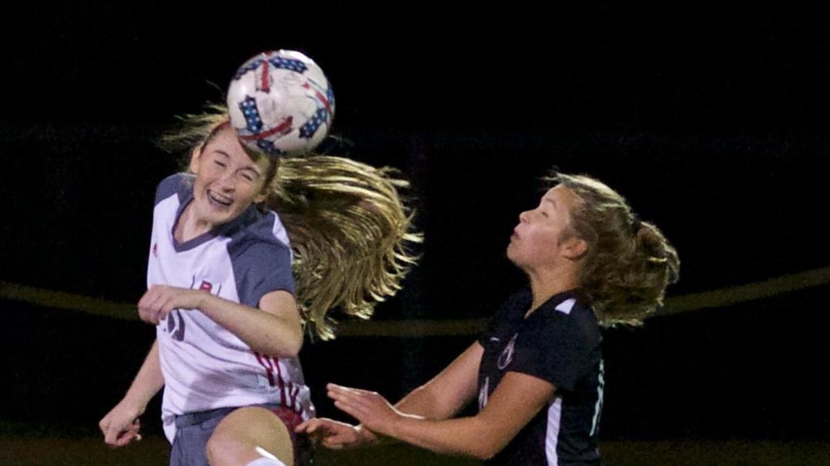 Bellingham’s Hannah Hodge heads the ball away from Cedarcrest’s Sarah Hommas during the second half of the 2A bi-district semifinals Oct. 31. Bellingham faces Columbia River Saturday in the 2A state quarterfinals.