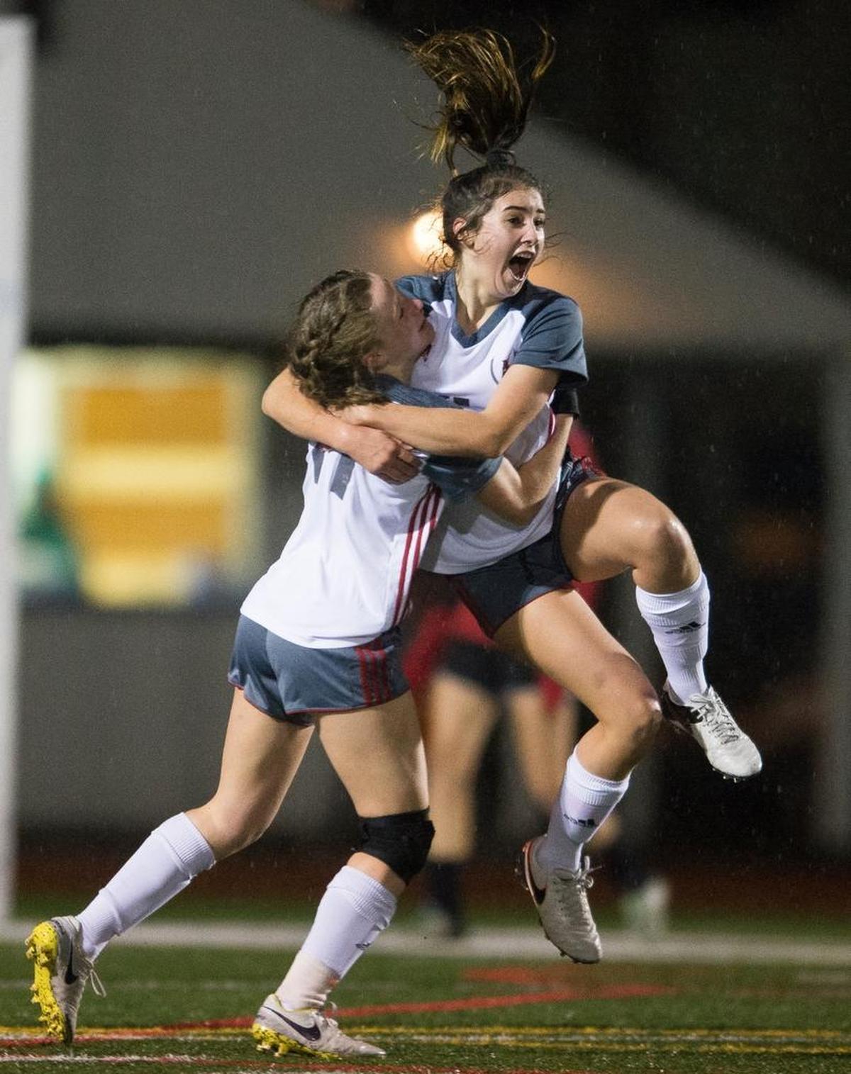 Bellingham’s Allison Krell, center right, celebrates with her teammate Jillian Langei after scoring a goal against Archbishop Murphy on Thursday, Nov. 2, at Sedro-Woolley High School. Bellingham advanced to state with the 5-3 victory.