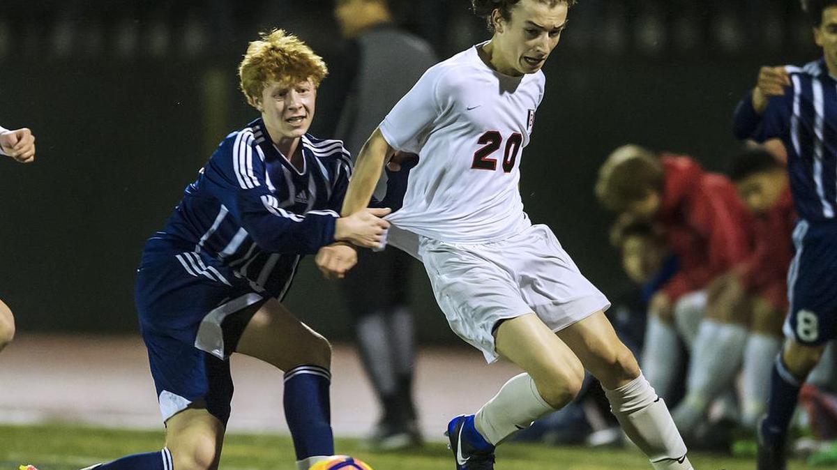 Squalicum midfielder Carl Peterson, left, and Bellingham defender Oliver Knickrehm battle for the ball in Squalicum’s 2-0 win on Tuesday at Civic Stadium. Red Raiders coach Matt Zigulis still saw “a lot of positives” in Bellingham’s play.