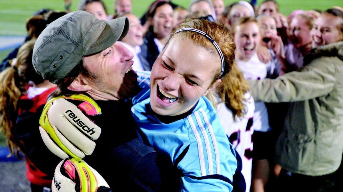 Bellingham goalie Hannah Jacobus is hugged by head coach Mark Wright after Bellingham beat Squalicum 2-1 in a 2013 state semifinal. Wright announced that he is stepping down from coaching the Red Raider soccer and girls basketball programs. Jared Fields takes over the soccer team.