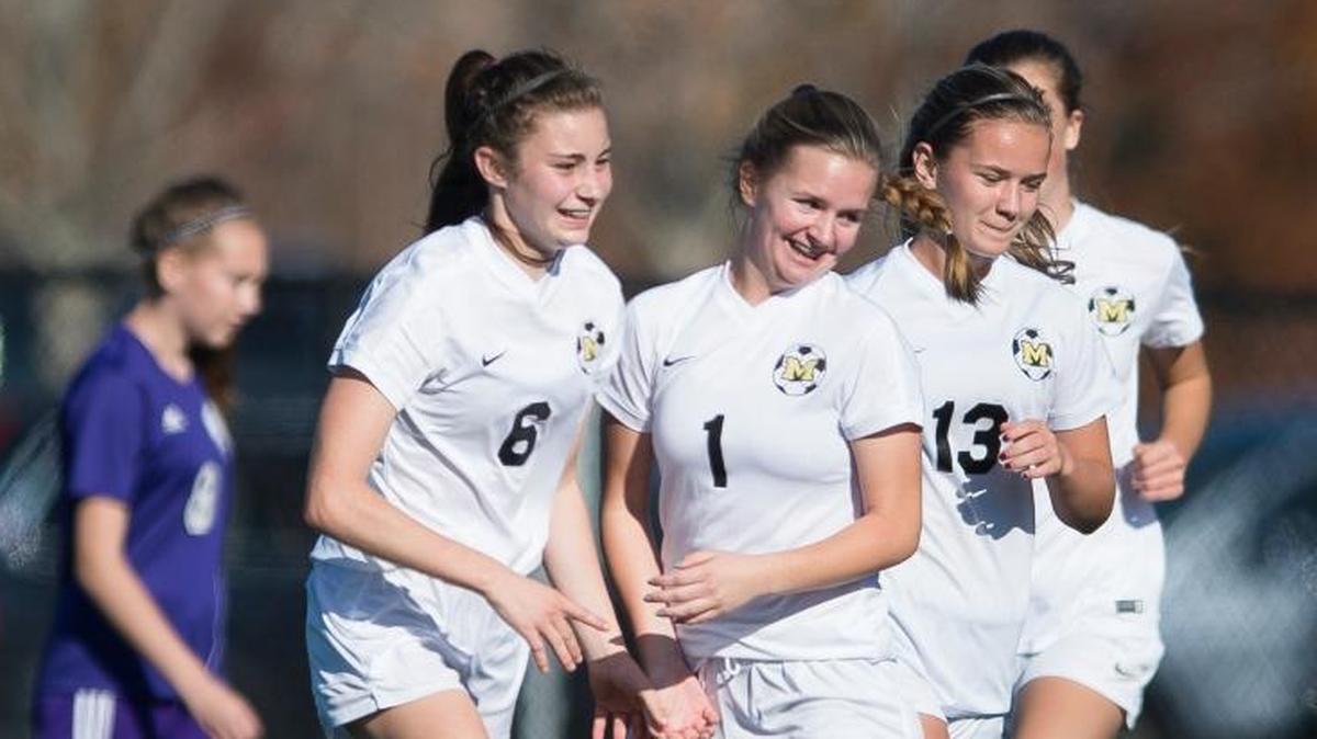 Meridian's Karissa Benson, left, celebrates with teammates Kailee Richter and Victory Melnyk after scoring a goal during a 5-0 victory over Nooksack Valley in the third-place game of the Class 1A Northwest District Tournament Saturday, Oct. 28, at Whatcom Community College in Bellingham.