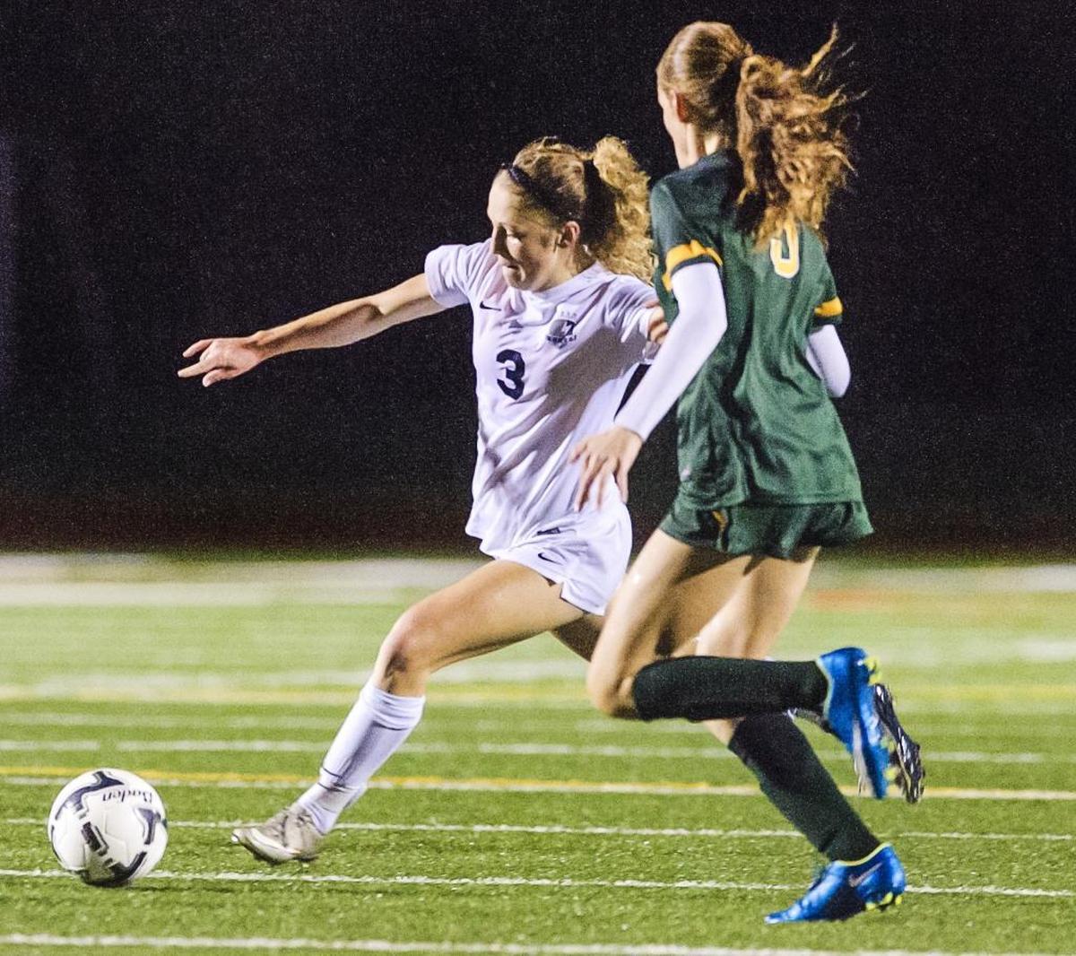 Squalicum's Kim Hazlett works her way around Shorecrest's Shay Adamsto take a shot on goal during the first half of the Class 2A Northwest District Championship game Nov. 7 at Sedro-Woolley High School.