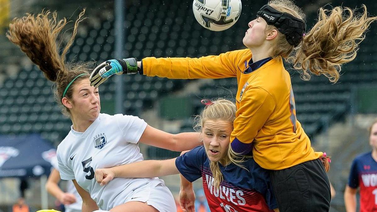 Squalicum’s Braeden Hilleary, left, watches as the ball goes over Black Hills defender Janae Grimm, right, and goalkeeper Jordan Westby during the first half of the Class 2A Girls' Soccer State Quarterfinals on Saturday, Nov. 14, at Civic Stadium in Bellingham.