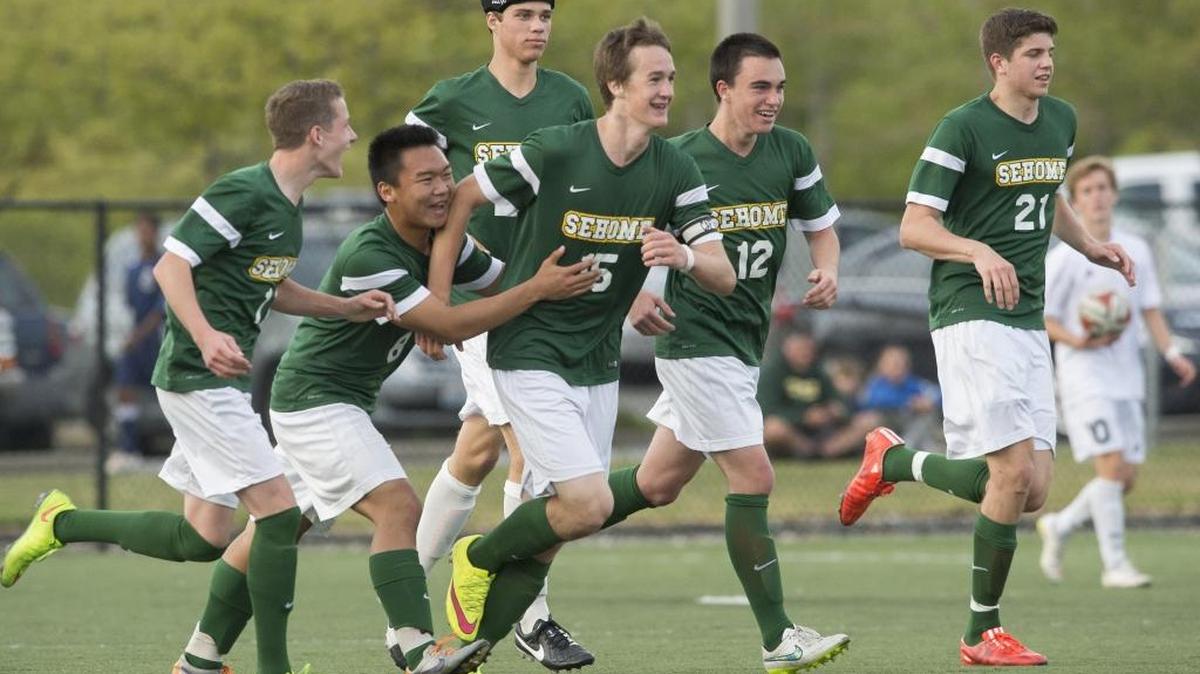 Sehome's Gabe Weight, center, celebrates with teammates after scoring a goal against Squalicum in a 2A District Tournament game Saturday, May 9, 2015, at Orca Field in Bellingham.