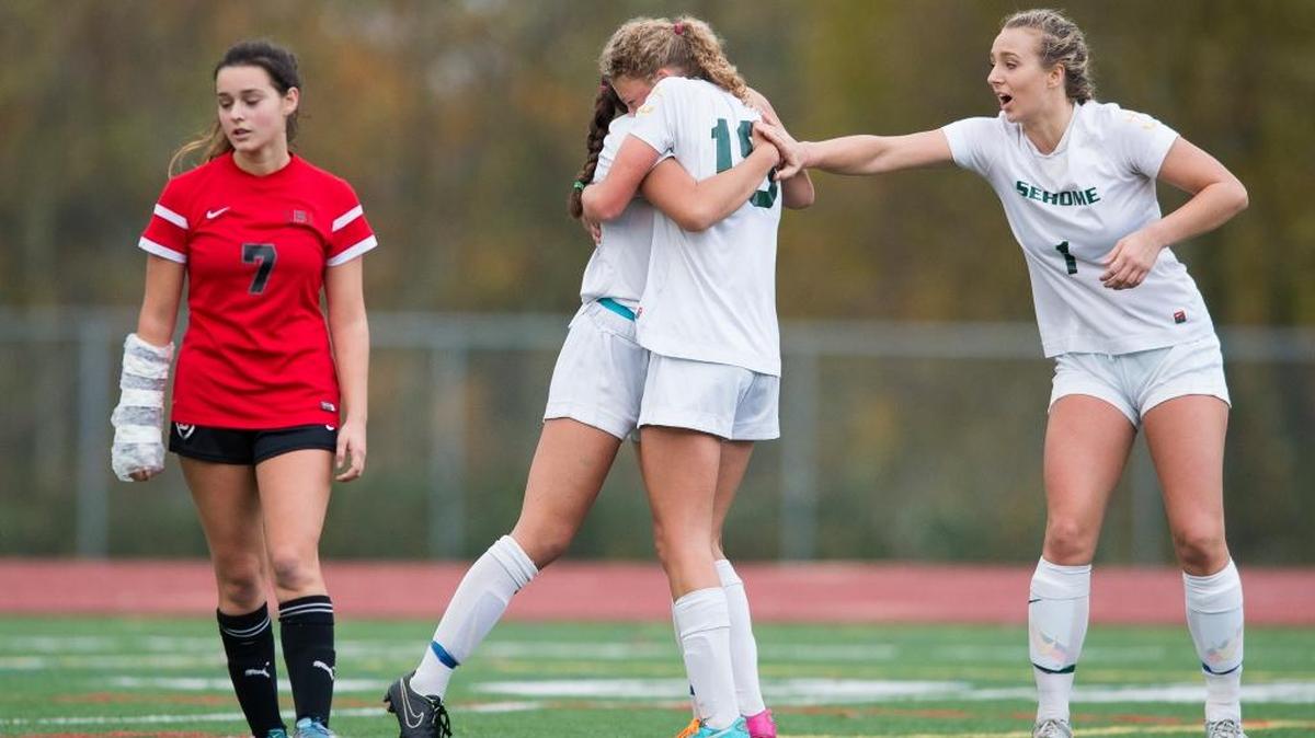 Sehome’s Sophia Pagnotta, center left, celebrates with Anna Snodgrass, center right, and Christina Funk, right, after scoring in the Mariners’ 3-1 win over Bellingham in the quarterfinals of the Class 2A Northwest Bi-District Tournament.