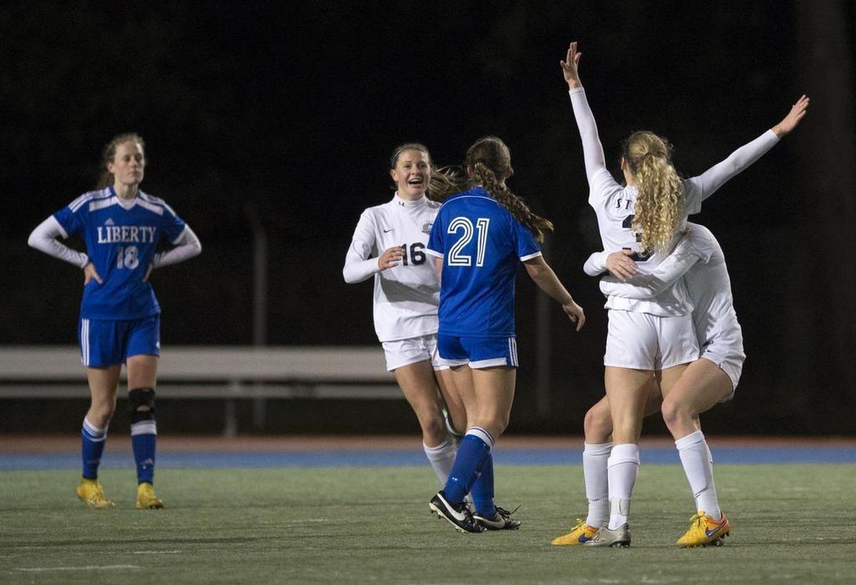 Squalicum’s Kim Hazlett (3) celebrates with teammates during the Storm’s 2-0 win over Liberty 2-0 in the semifinals of the Class 2A State Girls' Soccer Tournament on Friday, Nov. 20, at Shoreline Stadium.