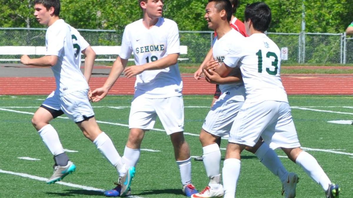 Sehome’s Manny Pacheco-Rodriguez (13) hugs Kevin Sun after Sun scored the game-winning goal in the 76th minute during a Class 2A Northwest District Tournament first round game on Saturday, May 7, at Civic Stadium.
