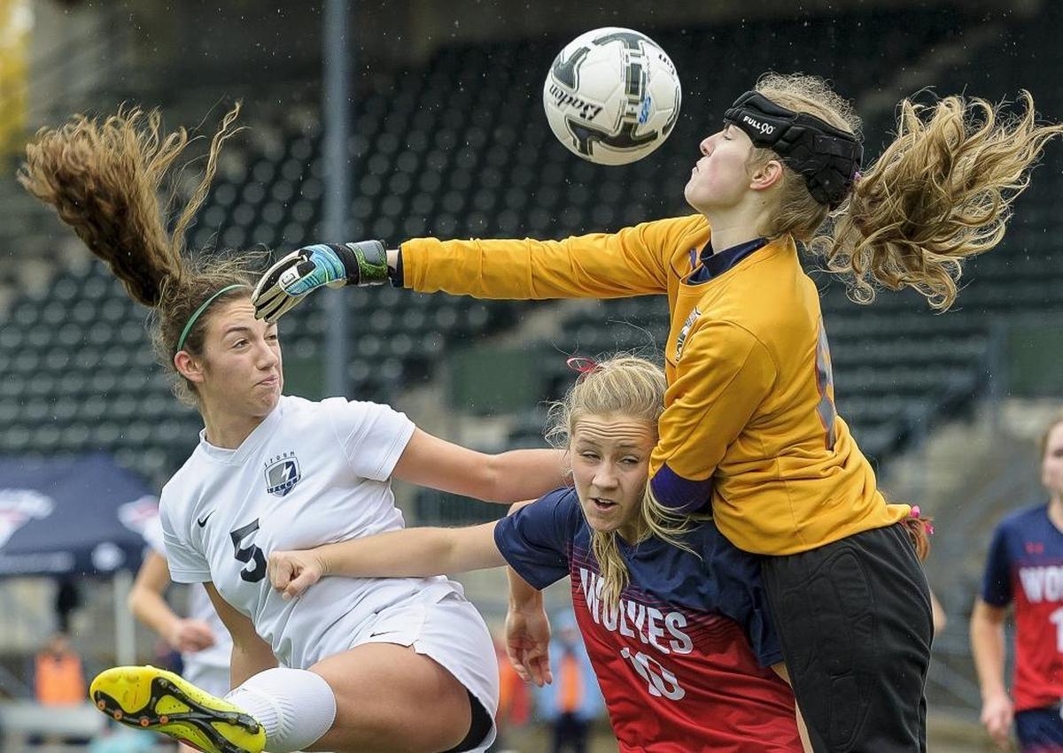 Squalicum's Braeden Hilleary watches as the ball goes over Black Hills defender Janae Grimm and goalkeeper Jordan Westby during the first half of the Class 2A Girls’ Soccer State Quarterfinals Nov. at Civic Field in Bellingham. Squalicum defeated Black Hills 6-0 to advance to the semifinals.