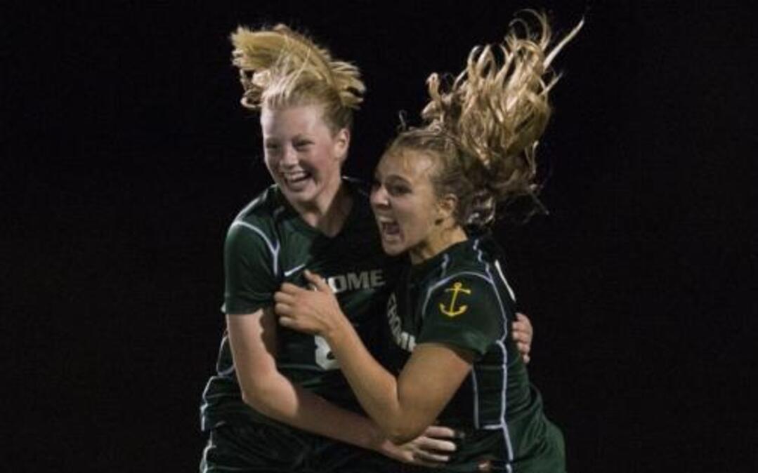 Sehome’s Christina Funk, right, celebrates with teammate Fiona Dawson after scoring a goal against Bellingham in Sept. 2014. Dawson has signed to play soccer at Highline College.