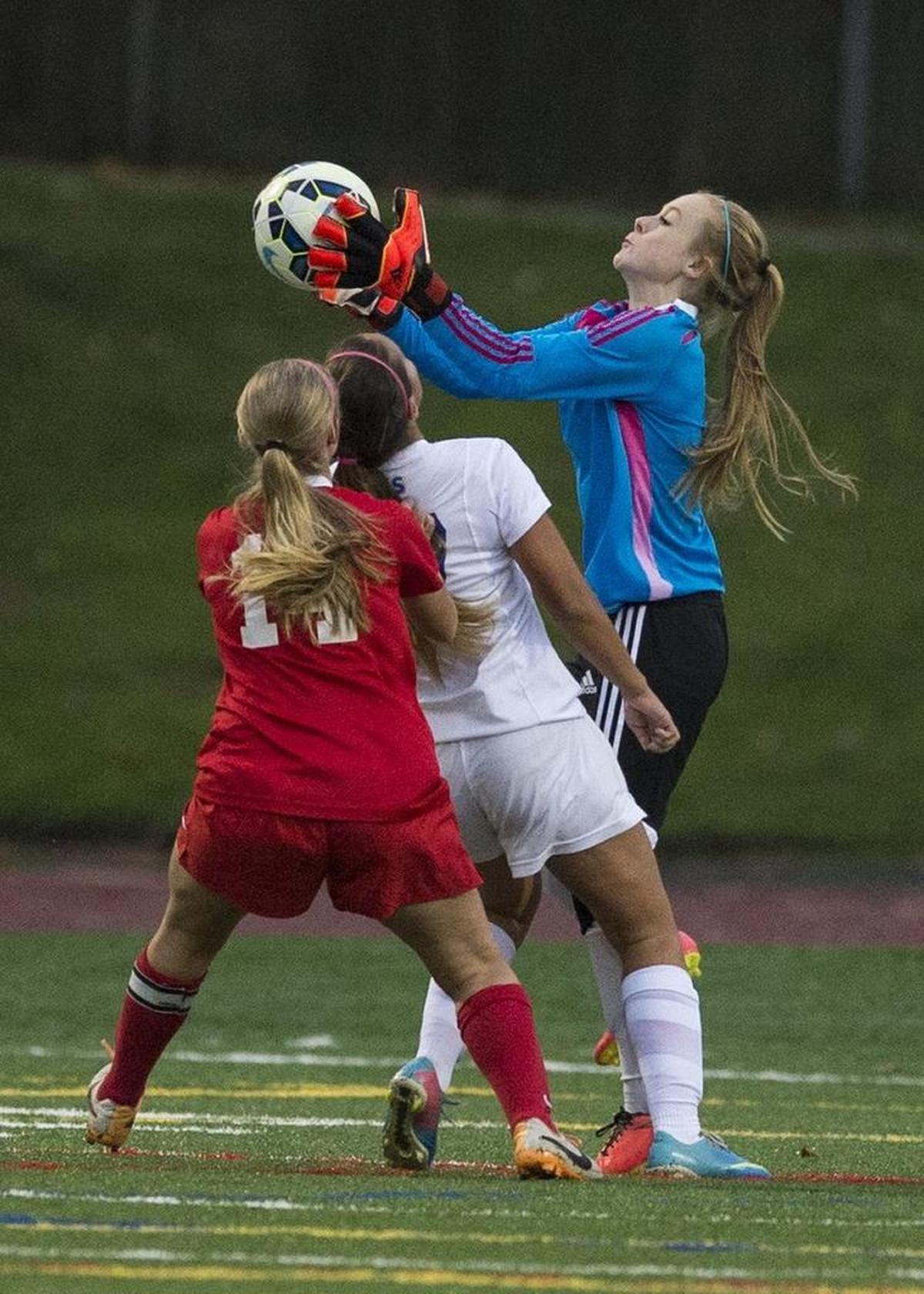 Ferndale goalkeeper Rachel Neher snags a ball as a Stanwood forward pursues on Thursday, Nov. 6, 2014, at Civic Stadium.