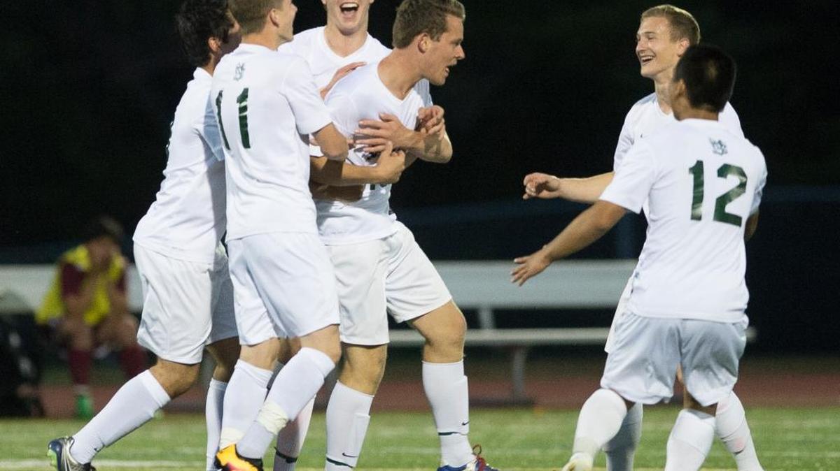 Sehome's Ethan Hunger is swarmed by teammates after scoring a goal during a 2-1 victory over Cedarcrest to advance to the 2016 Northwest District 1 2A Boys Soccer Tournament championship game on Tuesday, May 10, at Civic Stadium.