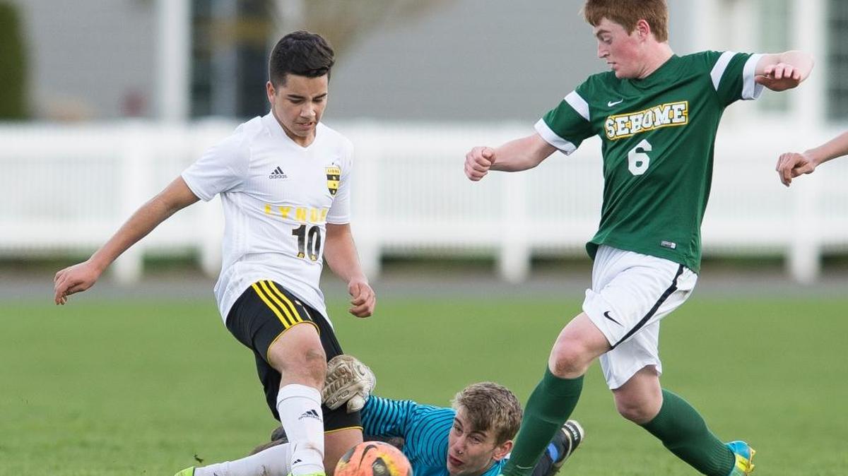 Lynden’s Jose Rios battles for control of the ball with Sehome’s Mason Kealy, center, and Jordan Byford on Thursday, April 13, at Bender Fields in Lynden.