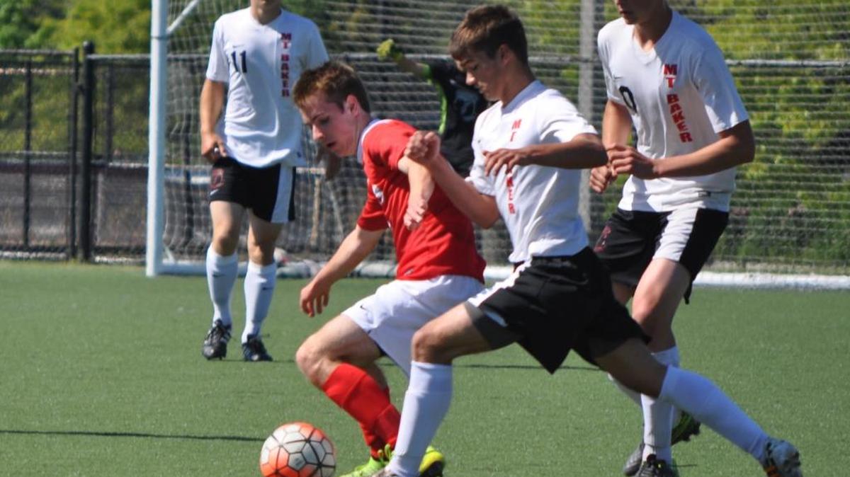 King’s Landon Hawley, left, and Mount Baker’s Talyn Donk battle for the ball during the Class 1A Northwest District championship game Saturday, May 7, at Whatcom Community College.