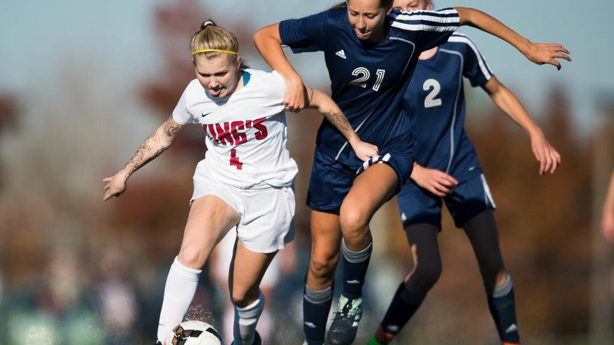 Lynden Christian’s Tara Hollander, right, battles for control of the ball with King’s Callie Wright on Saturday, Oct. 28, at Whatcom Community College in Bellingham during the Class 1A Northwest District Tournament title game.