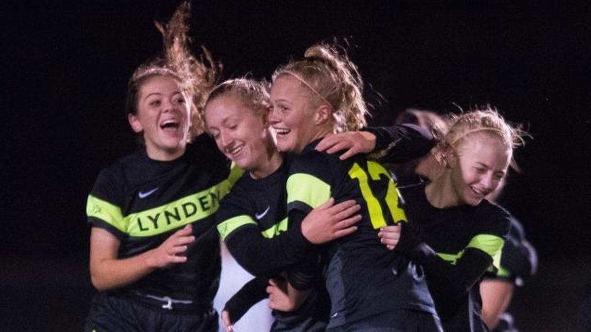 Lynden players celebrate after winning a 3-2 game against Sehome in overtime on a goal by Keylie Hershey, center left, off an assist by Ali VanZanten, right, on Thursday, Nov. 2, at Sedro-Woolley High School.