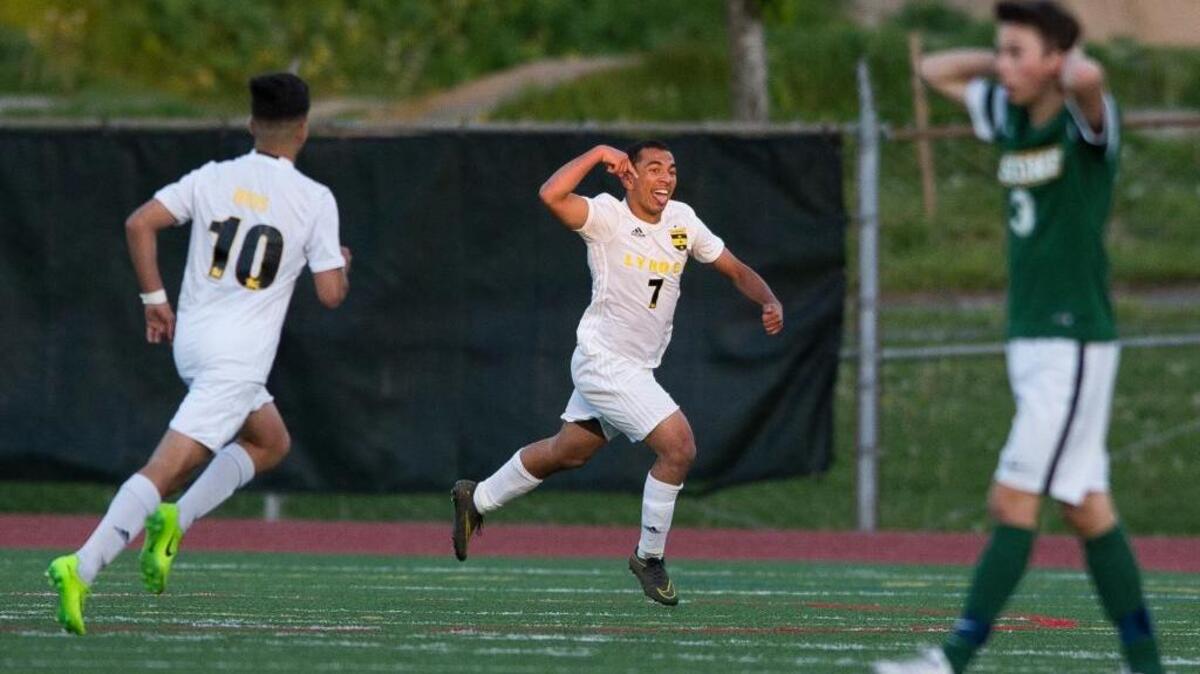 Lynden’s Nick Parris, center, celebrates after scoring a goal in the 79th minute to defeat Sehome 2-1 in the Class 2A Bi-District Tournament on Saturday, May 6, at Civic Stadium in Bellingham.