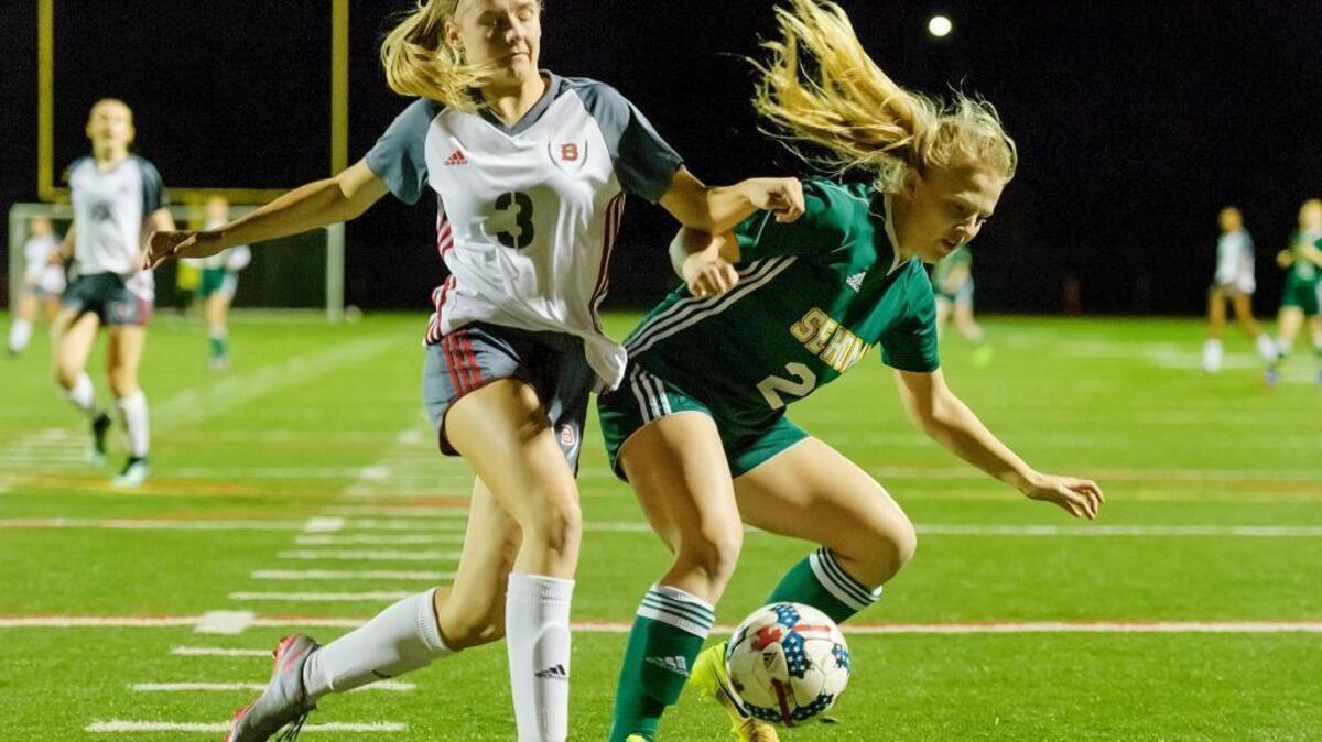 Bellingham sophomore defender Tessa Perry, left, stops Sehome senior midfielder Payton Kapp from attacking the goal early in the first half on Thursday at Civic Stadium.