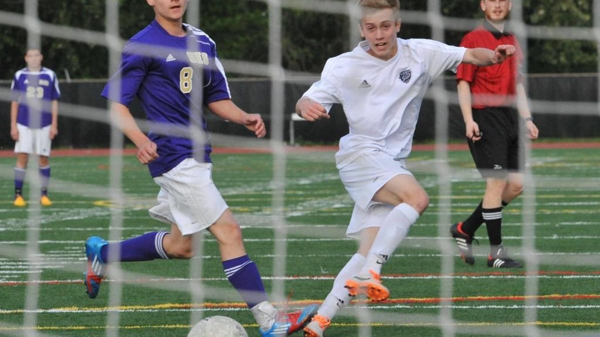Squalicum’s Tyler Hughes, right, puts a shot on goal against Sumner during the first round of the 2014 Class 2A State Playoffs. Hughes was selected Athlete of the Week by the WIAA after a big game last week.