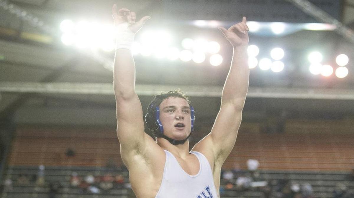 Ferndale’s Ben Broselle raises his arms in the air after defeating Yelm’s Jeremy Smith to earn his second consecutive Class 3A state championship at Mat Classic XXIX Feb. 18 at the Tacoma Dome.