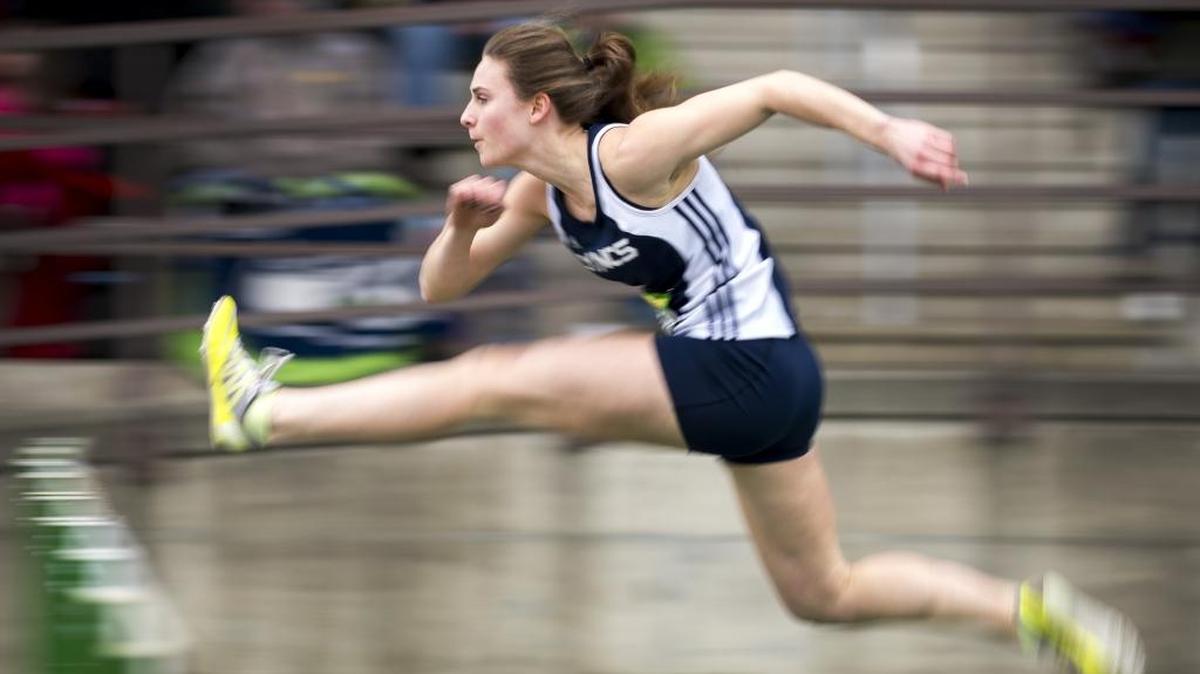 Lynden Christian’s Hannah Rusnak runs to a first-place finish in the girls 100 meter hurdles at the Bedlington Twilight Invitational on March 24, in Lynden.