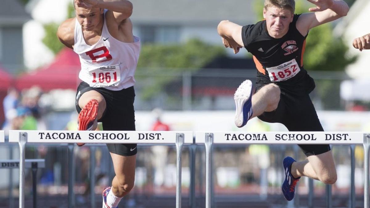 Bellingham's Benjamin Doucette, left, races toward a second place finish in the 110 meter hurdles at the Class 2A Track and Field State Championships May 29 in Tacoma. Doucette, now a senior, has signed to compete for the University of Idaho.