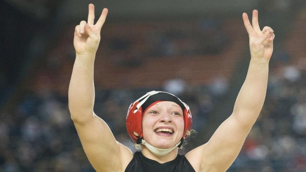 Mount Baker’s Emma Bruntil celebrates after pinning Red- mond’s Nadia Medvinsky at the Mat Classic on Saturday