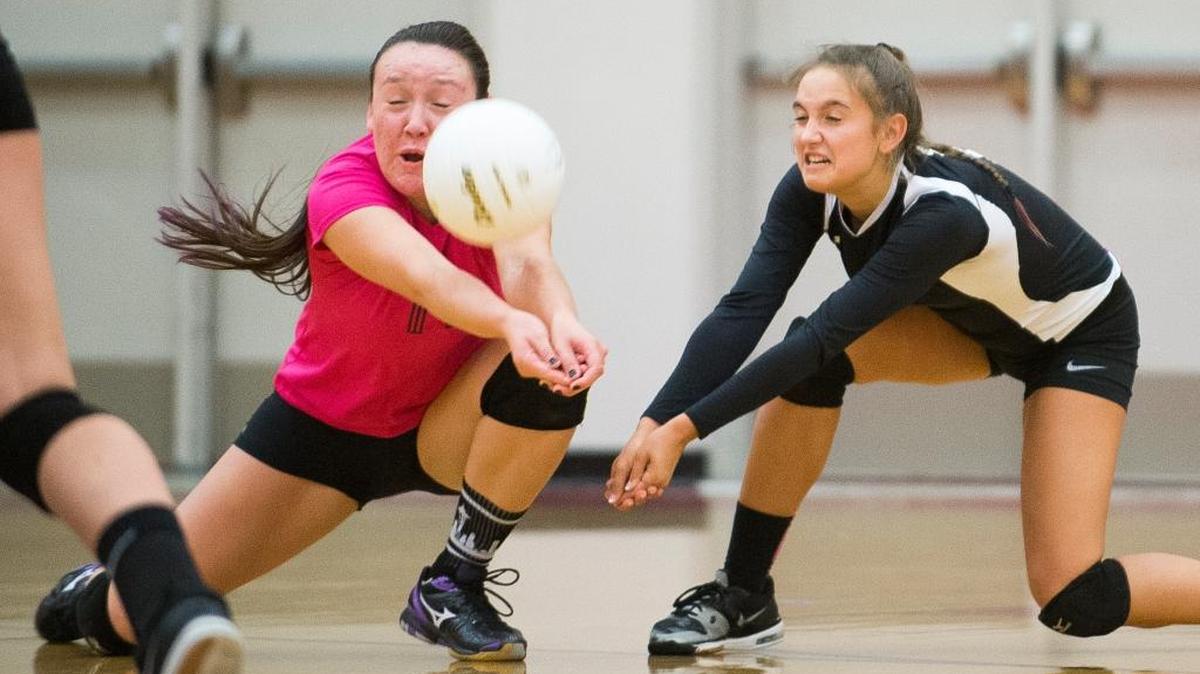 
Bellingham's Summer Douglas, left, and Sophia Lawrence lunge to keep the ball in play during a 3-0 victory over Meridian on Tuesday, Oct. 13, at Bellingham High School.
