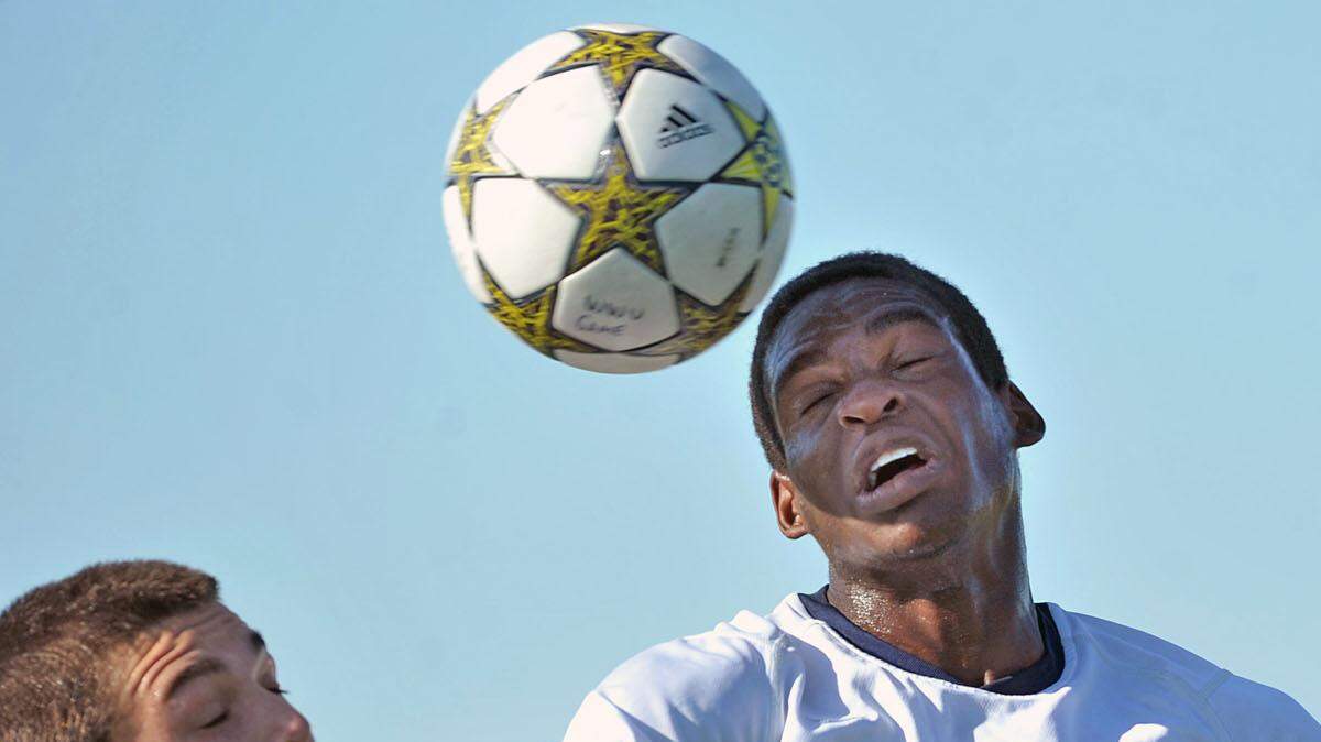 Western Washington University's Uche Ugwoaba, right, heads the ball over a Simon Fraser player in a 2012 game. Ugwoaba, a midfielder, is a three-year letter winner for the Vikings.