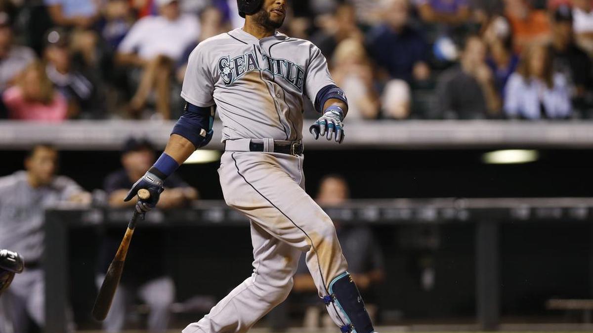 
Robinson Cano of the Mariners follows the flight of his RBI double off Rockies relief pitcher Gonzalez Germen in the seventh inning Monday in Denver. 
