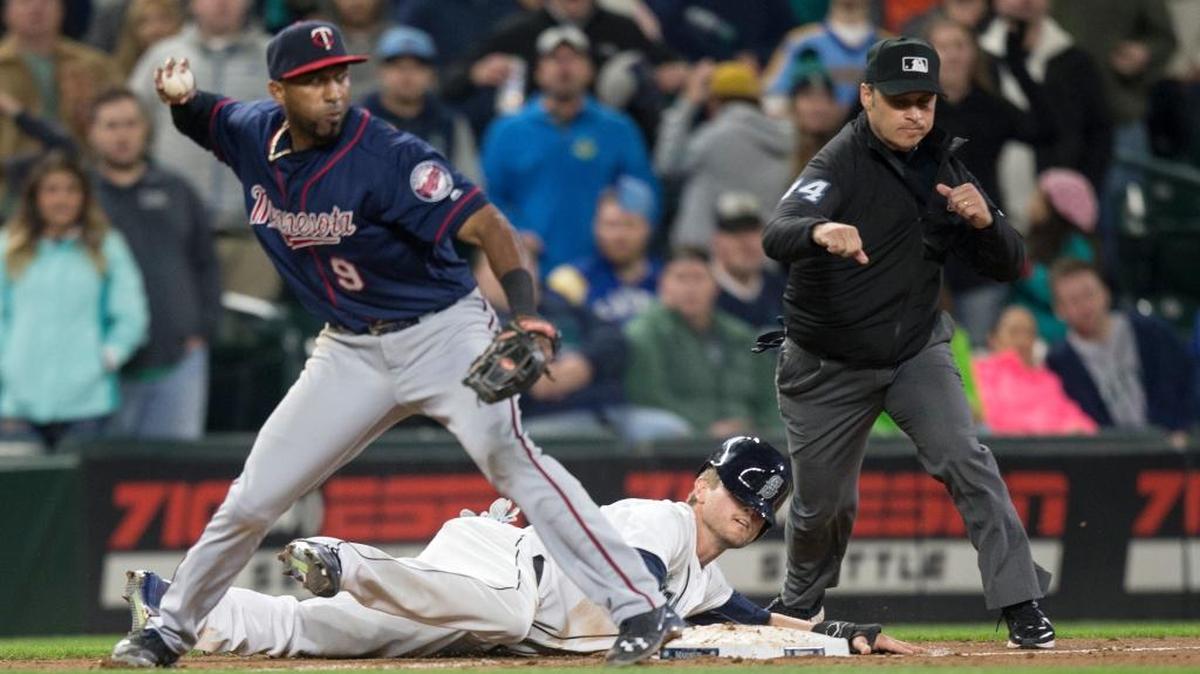 Seattle Mariners’ Shawn O’Malley lays on the ground after being tagged out caught stealing by Minnesota Twins third baseman Eduardo Nunez who threw to second to complete a double play in the ninth inning of a baseball game, on Saturday, May 28, 2016, in Seattle. The Twins won 6-5.