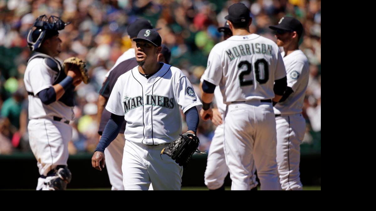 
Seattle Mariners starting pitcher Felix Hernandez, center, leaves the game in the seventh inning after allowing seven runs and 12 hits to Arizona as the Diamondbacks posted an 8-2 victory Wednesday at Safeco Field.
