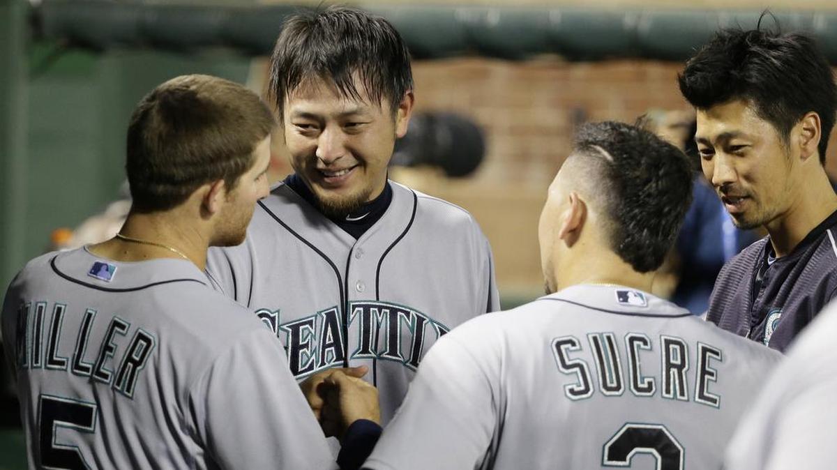 
Mariners starting pitcher Hisashi Iwakuma shares a laugh with teammates in the dugout after the seventh inning Tuesday. 
