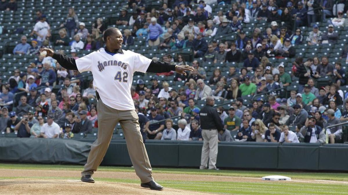 Dave Henderson, who played for Seattle from 1981-86 and worked as a Mariners broadcaster, throws out the first pitch before a Mariners game on Sept. 23, 2012.