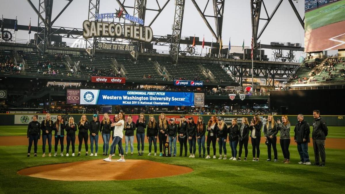 Western Washington senior defender Erin Russell throws out the ceremonial first pitch before the Seattle Mariners’ game gainst the Miami Marlins Tuesday at Safeco Field. Russell and the WWU women’s soccer team were honored before the game for winning a national title last fall.