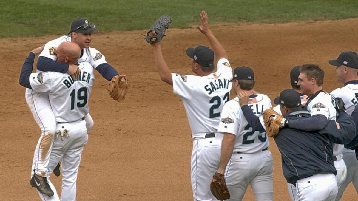 Jay Buhner (19) lifts up Bret Boone as teammates rush onto the field after the Seattle Mariners defeated the Cleveland Indians at Safeco Field in Game 5 of the American League Divisional Series on Oct. 15, 2001. The Mariners would go on to lose to the New York Yankees in the AL Championship Series, 4-1.