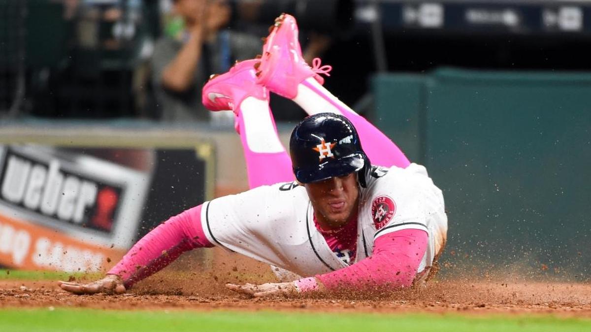Houston Astros’ George Springer slides safely home on Carlos Correa’s RBI single in the seventh inning of a baseball game against the Seattle Mariners, Sunday, May 8, 2016, in Houston.