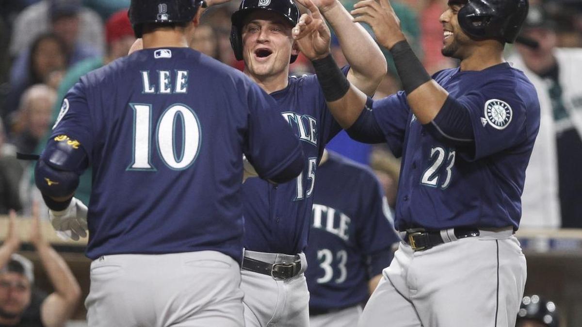The Seattle Mariners’ Dae-Ho Lee (10) is congratulated by Kyle Seager, center, and Nelson Cruz after Lee hit a three-run home run in the sixth inning against the San Diego Padres at Petco Park in San Diego on Thursday, June 2, 2016.