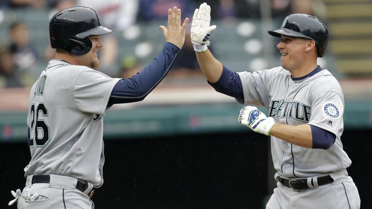 Seattle Mariners catcher Steve Clevenger, right, is congratulated by Adam Lind after Clevenger hit a two-run home run off Cleveland Indians starting pitcher Cody Anderson on April 21 in Cleveland. It’s Clevenger’s lone home run for the Mariners to date.