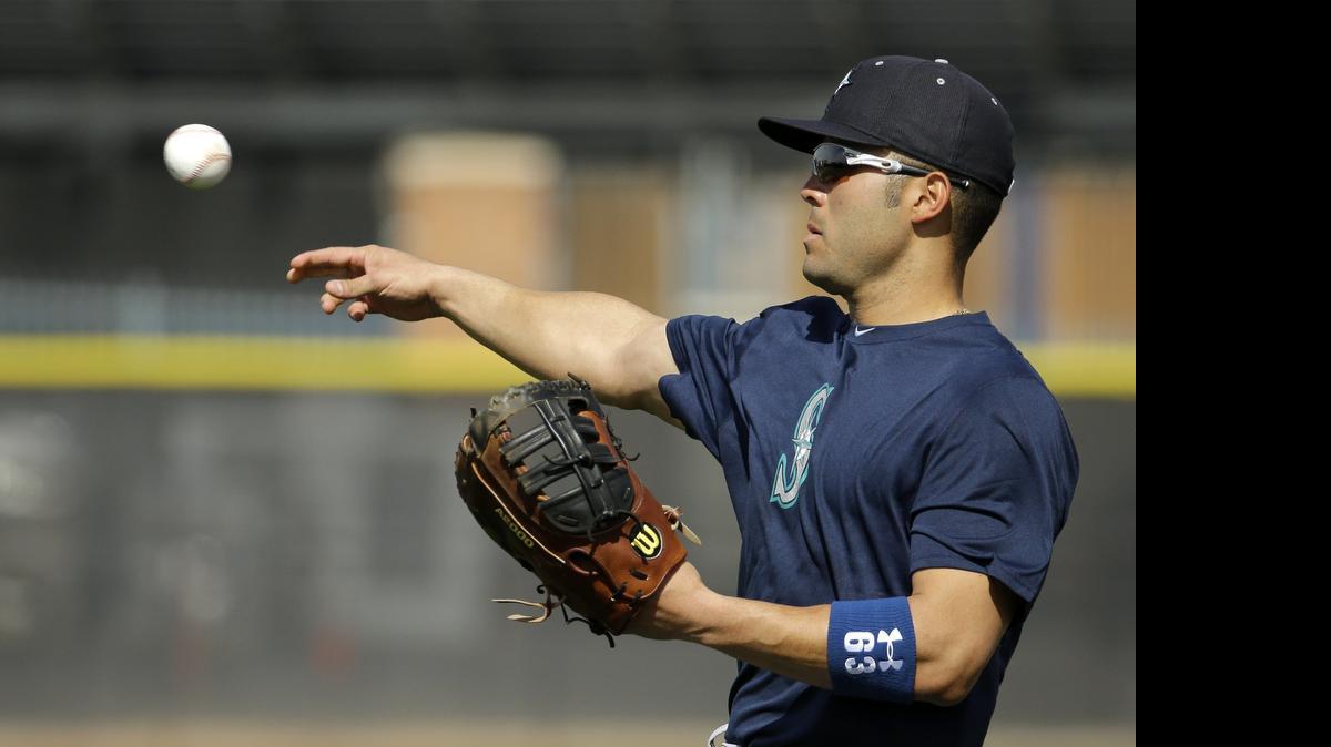 
Seattle Mariners' Jesus Montero throws during spring training baseball practice Saturday, Feb. 21, 2015, in Peoria, Ariz. 

