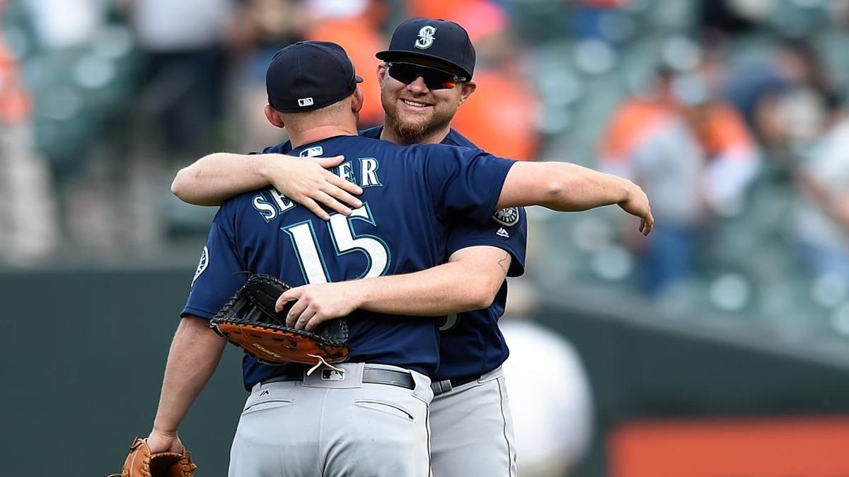 Seattle Mariners players Adam Lind, right, and Kyle Seager celebrate their 7-2 win over the Baltimore Orioles in a baseball game, Thursday, May 19, 2016, in Baltimore.