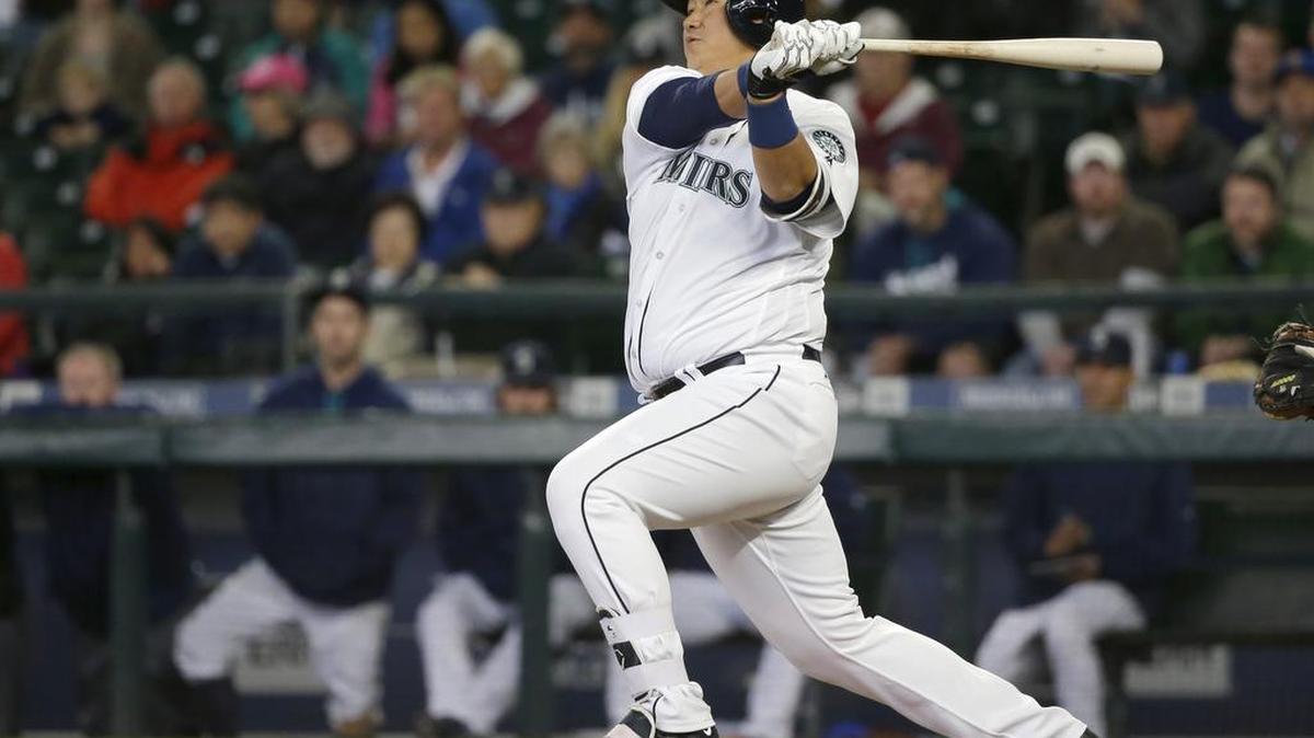 Seattle Mariners' Dae-Ho Lee watches his walk-off two-run home run in the 10th inning of a baseball game against the Texas Rangers, Wednesday, April 13, 2016, in Seattle. The Mariners won 4-2.