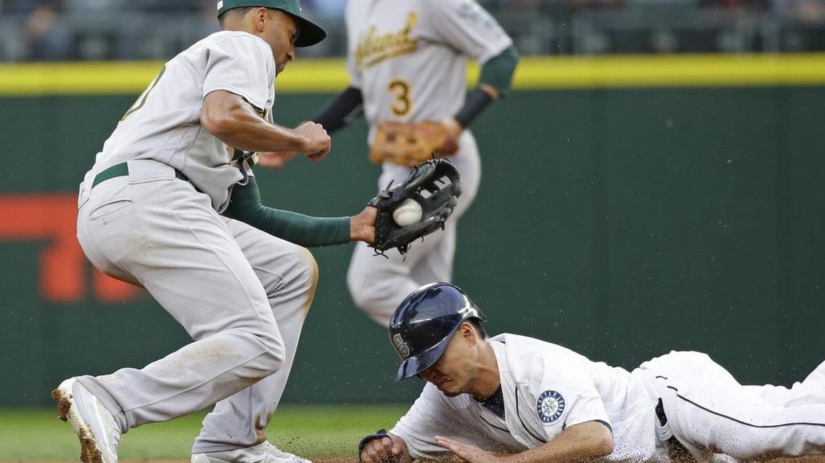 The Mariners’ Nori Aoki is tagged out by the A’s Marcus Semien trying to steal second base last month. Aoki has been caught stealing on seven of his 11 attempts this year.