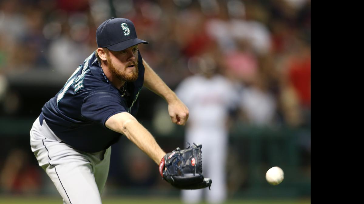 
Mariners reliever Charlie Furbush makes a glove throw to get Michael Brantley out at first base during the eighth inning. The play was upheld after the Indians challenged Brantley was safe. 
