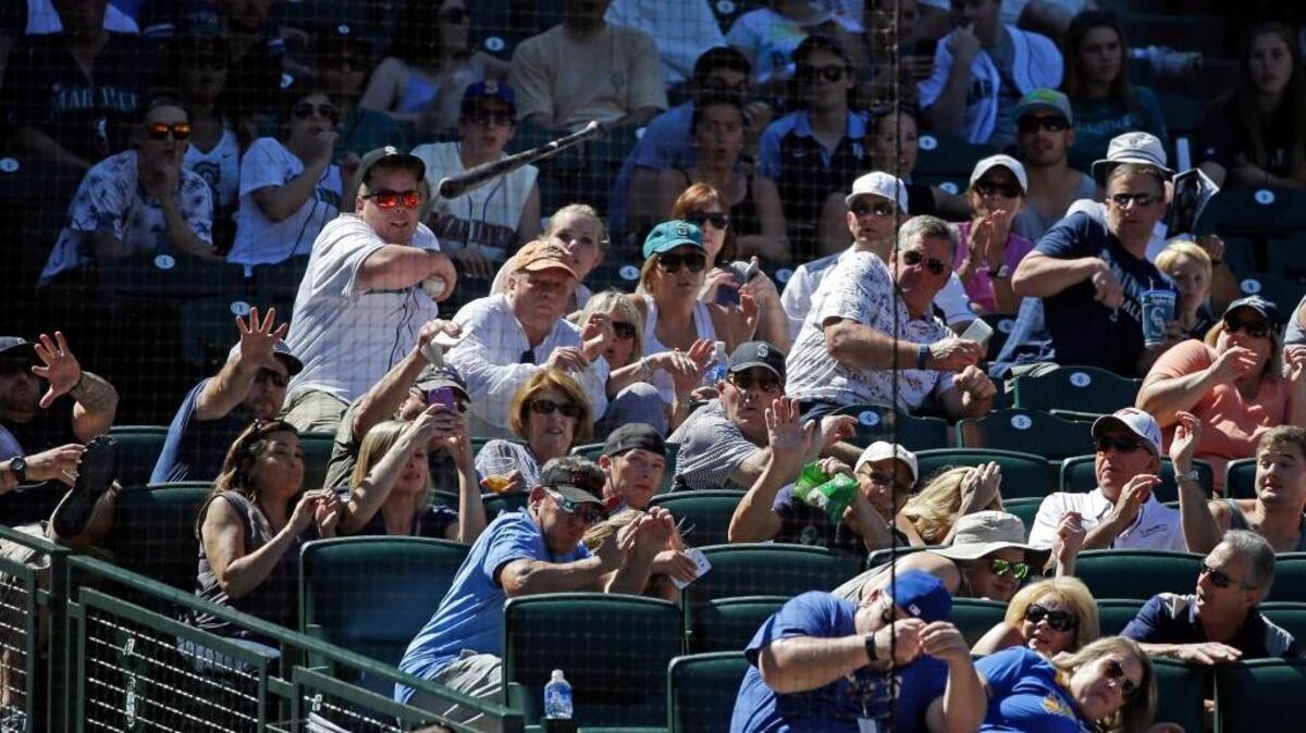
Fans duck as a bat from then-Seattle Mariners outfielder Rickie Weeks flies into the stands behind home plate during the eighth inning of a June game against Tampa Bay at Safeco Field.
