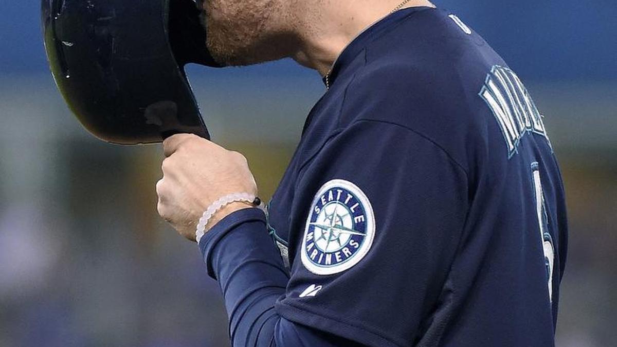 
Seattle’s Brad Miller covers his face after grounding out to end the top of the sixth inning against Kansas City. 
