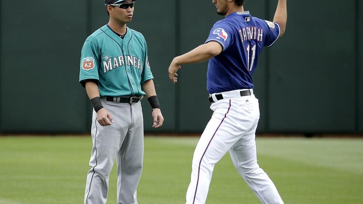 Seattle’s Nori Aoki, left, and Texas pitcher Yu Darvish talk before Sunday’s game. “Nori fit exactly what we were looking for” in a leadoff hitter, Mariners GM Jerry Dipoto says.